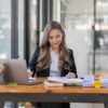 business Asian woman or accountant Bookkeeper working on calculator to calculate business data,